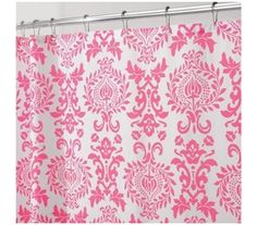 a shower curtain with pink and white damask