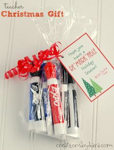 four different colored toothbrushes wrapped in cellophane and tied with a red ribbon