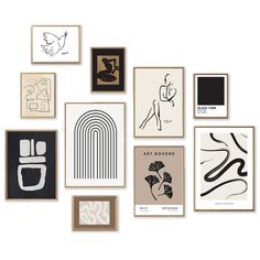 an assortment of framed art pieces displayed on a white wall in various shapes and sizes