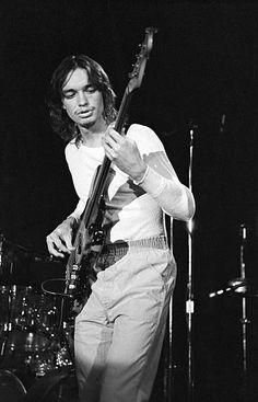 black and white photograph of a man playing guitar