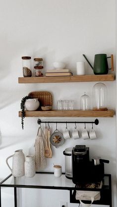 the shelves above the stove are filled with kitchen items and utensils, such as mugs