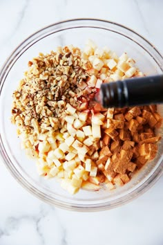 chopped apples and other ingredients in a glass bowl