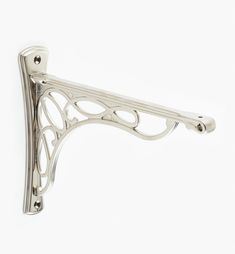 an ornate metal shelf bracket on a white background