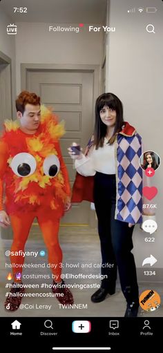 two people standing next to each other in front of a door with an orange monster costume on