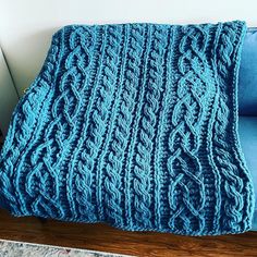 a blue blanket sitting on top of a couch