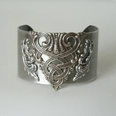 Celtic Bracelet This beautiful silver plated cuff bracelet has a silver plated celtic knot design.  1.5 inches wide. All components are nickel and lead free sterling silver plated over stainless steel. Hypoallergenic for no skin irritations or discolorations. The plating is high quality and will not chip or peel off. gothic victorian art deco renaissance celtic medieval style Fae Ball, Celtic Medieval, Victorian Bracelet, Celtic Bracelet, Bracelet Art, Medieval Gothic, Celtic Knot Designs, Nouveau Jewelry, Medieval Style