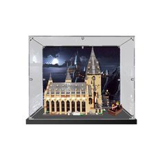 a lego hogwarts castle is shown in a glass case with the lights on