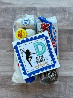 a bag filled with snacks and candy on top of a wooden table