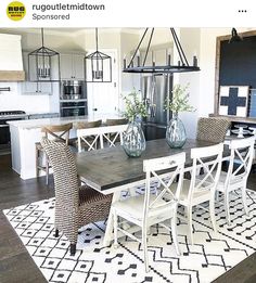 the dining room table is set with white chairs