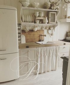 a white refrigerator freezer sitting inside of a kitchen