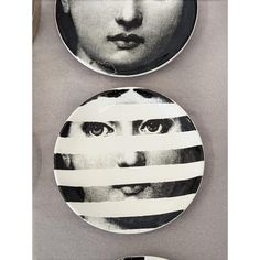 two plates with faces and lines painted on them