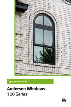 an image of a window on the side of a brick building with green trim and windows