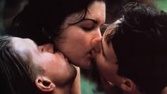 two people kissing each other in front of a poster for the film kiss on the cheek