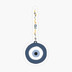 an eyeball hanging from a string on a white background sticker with blue and yellow accents