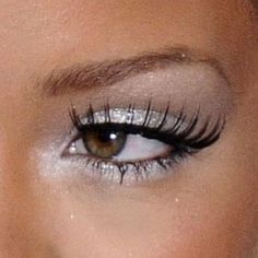 a close up shot of a woman's eye with long lashes and false eyelashes