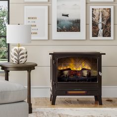 a living room with a fire place and pictures on the wall