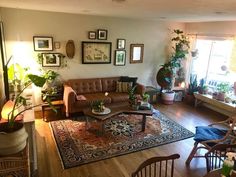 a living room filled with furniture and lots of plants