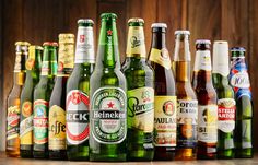 an assortment of beer bottles lined up on a table