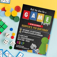 a birthday party card with dices and game pieces on the table next to it