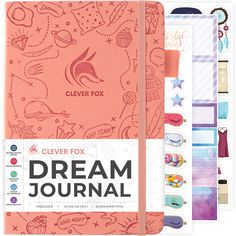 the clever fox dream journal is shown with stickers on it and an orange cover