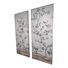 two framed paintings with flowers and birds on them