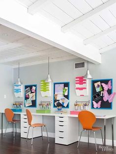 an office with three desks and two chairs in front of the desk is decorated with colorful pictures