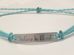 "This is an engraved waterproof bracelet, It is shown with an engraved brushed stainless steel bar and mint straps. You can choose your metal color and strap color. The bar will be engraved with \"Sisters in Christ\". You can choose back side engraving for personalization during checkout. Please let us know if you have any questions! The back can also be engraved. CHARACTER LIMIT- 14 characters per side Each item is made-to-order, which gives our pieces a unique meaning that is specific and spec Waterproof Bracelet, Unique Meaning, Medical Bracelet, Inspirational Bracelets, Stainless Steel Bar, Cross Bracelet, Steel Bar, Team Gifts, Custom Bracelets