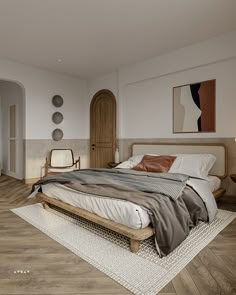 a bed sitting on top of a wooden floor in a bedroom