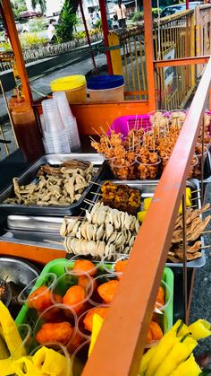 there are many different types of food on the table at this street side vendor's stand