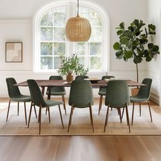 a dining room table surrounded by green chairs