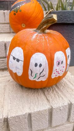 two pumpkins with faces painted on them