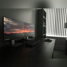 a desktop computer sitting on top of a wooden desk next to a monitor and keyboard