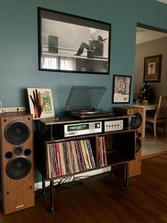 a record player sitting on top of a wooden shelf next to a wall mounted cd player