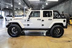 a white jeep is parked in a garage