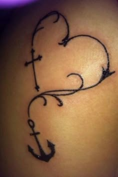 an anchor and heart tattoo on the back of a woman's thigh, with black ink