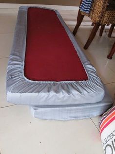 an inflatable mattress is laying on the floor next to a pillow and two chairs