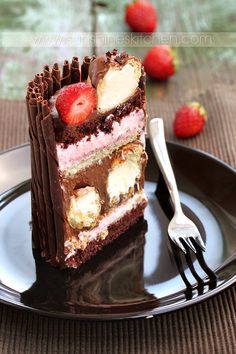 a piece of cake on a plate with a fork and strawberries in the background