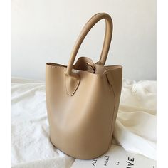 Beige Handheld Bucket Bag, Handheld Beige Bucket Bag With Phone Holder, Beige Bucket Bag With Large Capacity And Top Handle, Beige Top Handle Bucket Bag With Large Capacity, Solid Color Bucket Hobo Bag With Adjustable Strap, Trendy Leather Bucket Shape Shoulder Bag, Trendy Leather Bucket Shoulder Bag, Adjustable Strap Bucket Hobo Bag, Solid Color Large Capacity Faux Leather Bucket Bag