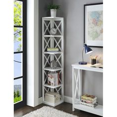 a white book shelf sitting on top of a hard wood floor next to a wall