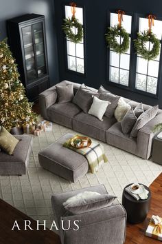 a living room filled with furniture and a christmas tree