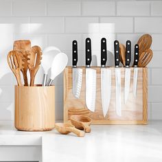 kitchen utensils in wooden holder on counter