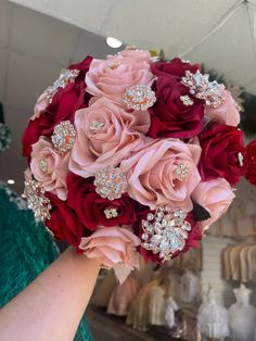 a bridal bouquet with red and pink flowers