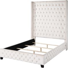 an upholstered white bed frame with buttons