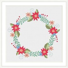 a cross stitched christmas wreath with poinsettis