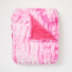 a pink and white blanket with a red triangle on the top in front of a white background