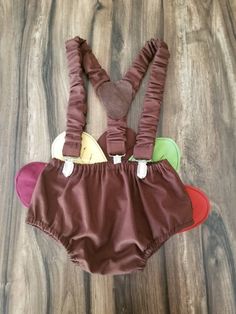 This outfit is meant to get messy! To be worn for first birthday photo shoot or cake smash. Outfit includes solid brown diaper cover with fabric turkey tail in orange/green/brown/rust/yellow, brown suspenders, fall chevron bow tie and brown collar with hook and loop adjuster, and brown top hat with cream accents, coordinating 1 and feathers. DC only: diaper cover only DC and bow tie: diaper cover and bow tie Set no hat: diaper cover, suspenders, and bow tie Top hat only: top hat only Entire set First Birthday Playful Cotton Diaper Cover, Unisex Diaper Cover For Playtime, Thanksgiving Turkey Cake, Fabric Turkey, Cake Smash First Birthday, Turkey Cake, Brown Suspenders, Bow Tie Top, First Birthday Outfit