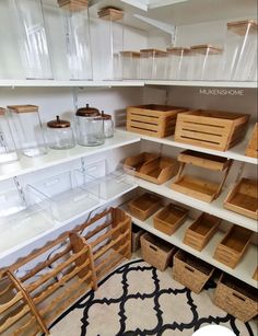 an organized pantry with wooden baskets and bins