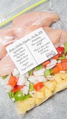 raw chicken breast fillets with vegetables and pineapples for sale in a plastic bag