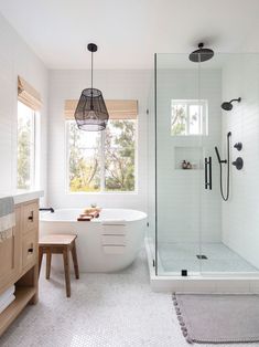 a bathroom with a tub, sink and window