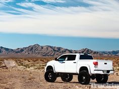 a white truck is parked in the desert